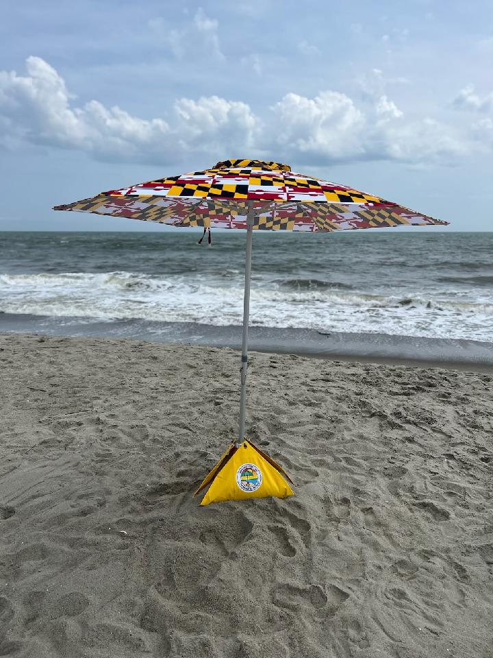 limited edition maryland flag beach umbrella set up at the beach