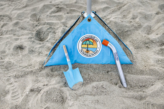 woman adding sand to ultimate beach umbrella base