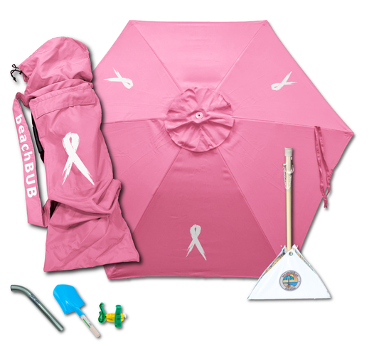 pink beach umbrella setup on windy beach