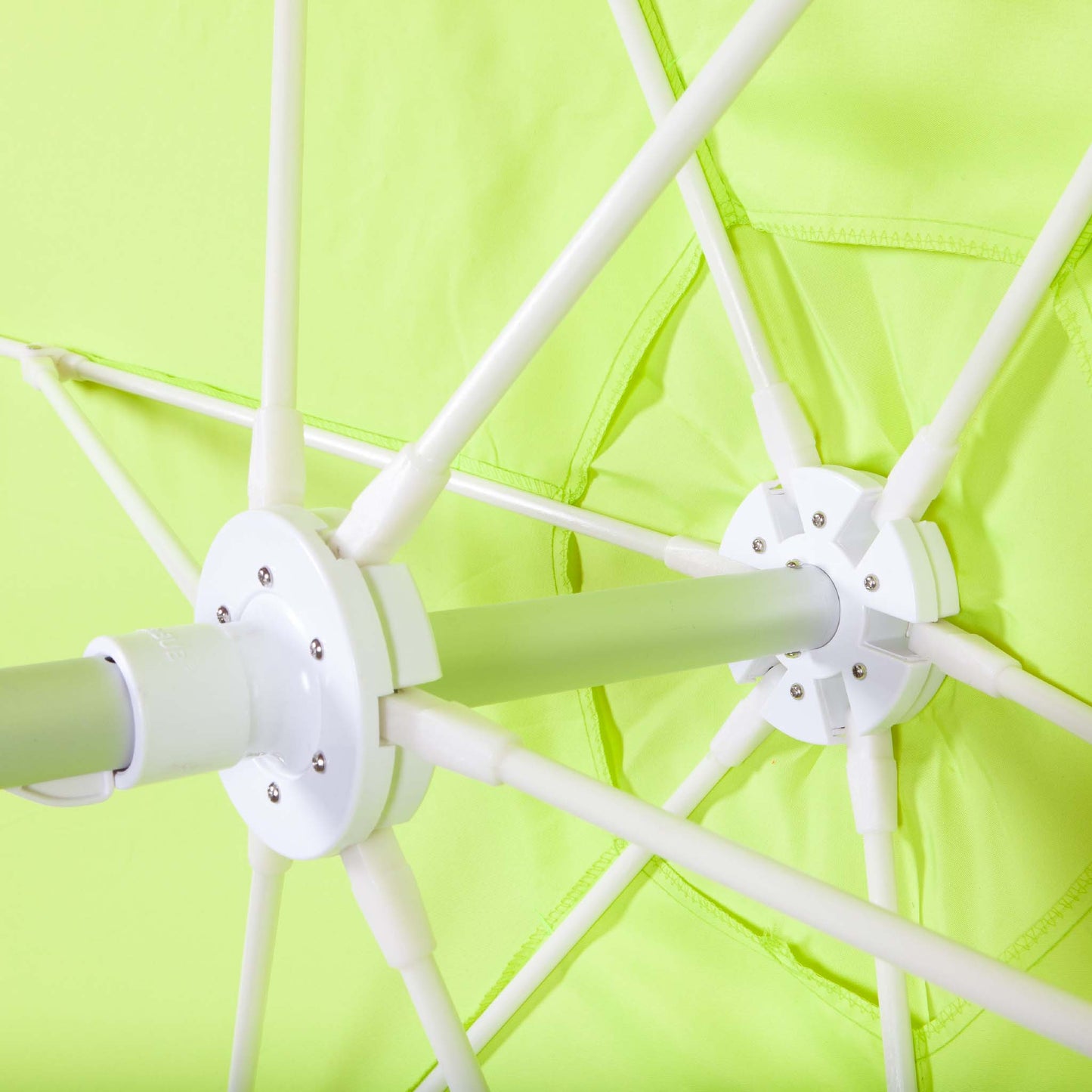 underneath lime green beach umbrella canopy