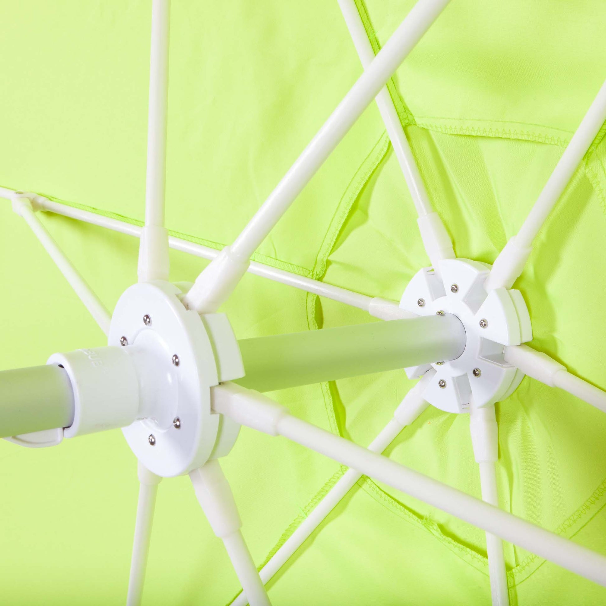 underneath lime green beach umbrella canopy