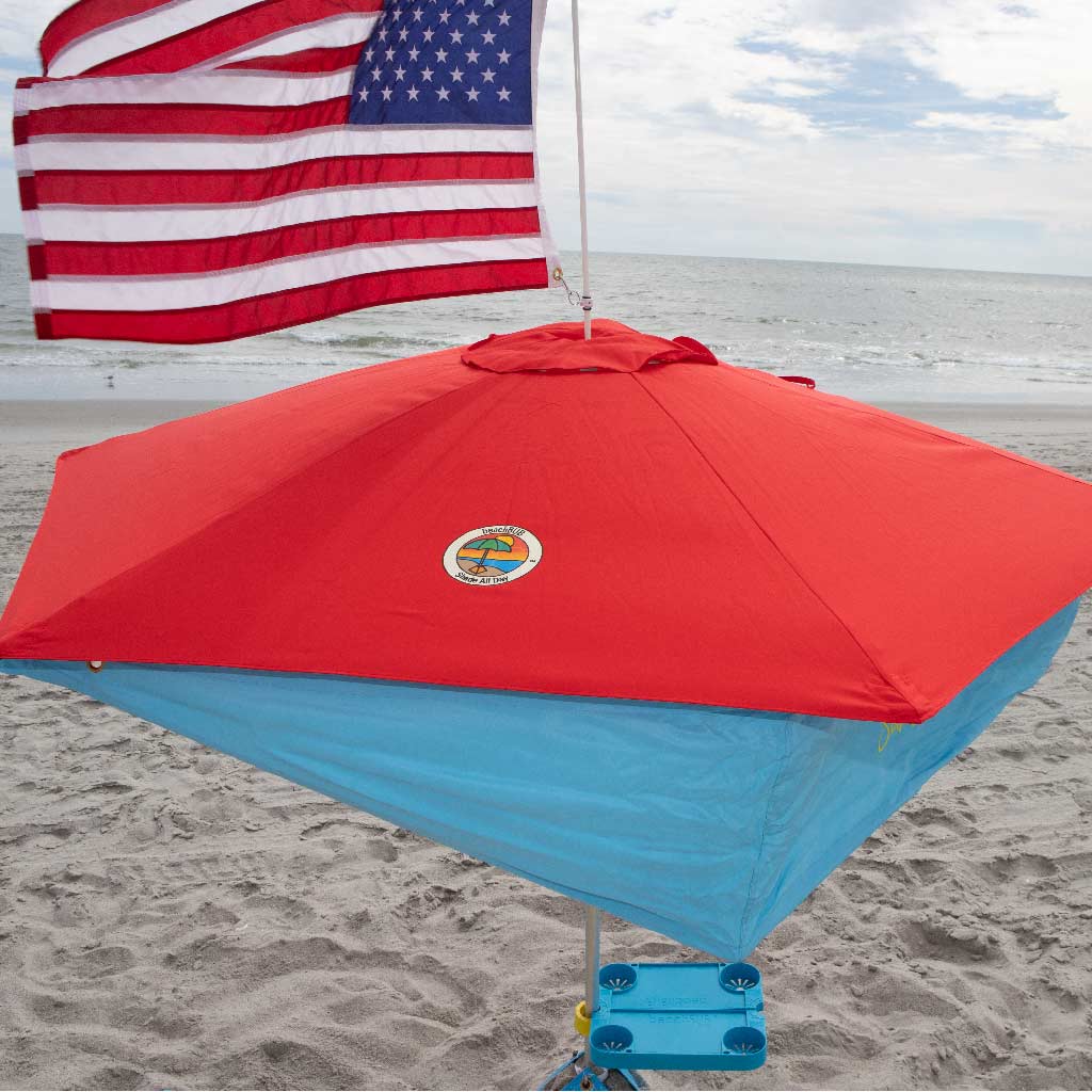 wind resistant beach umbrella with red canopy and american flag