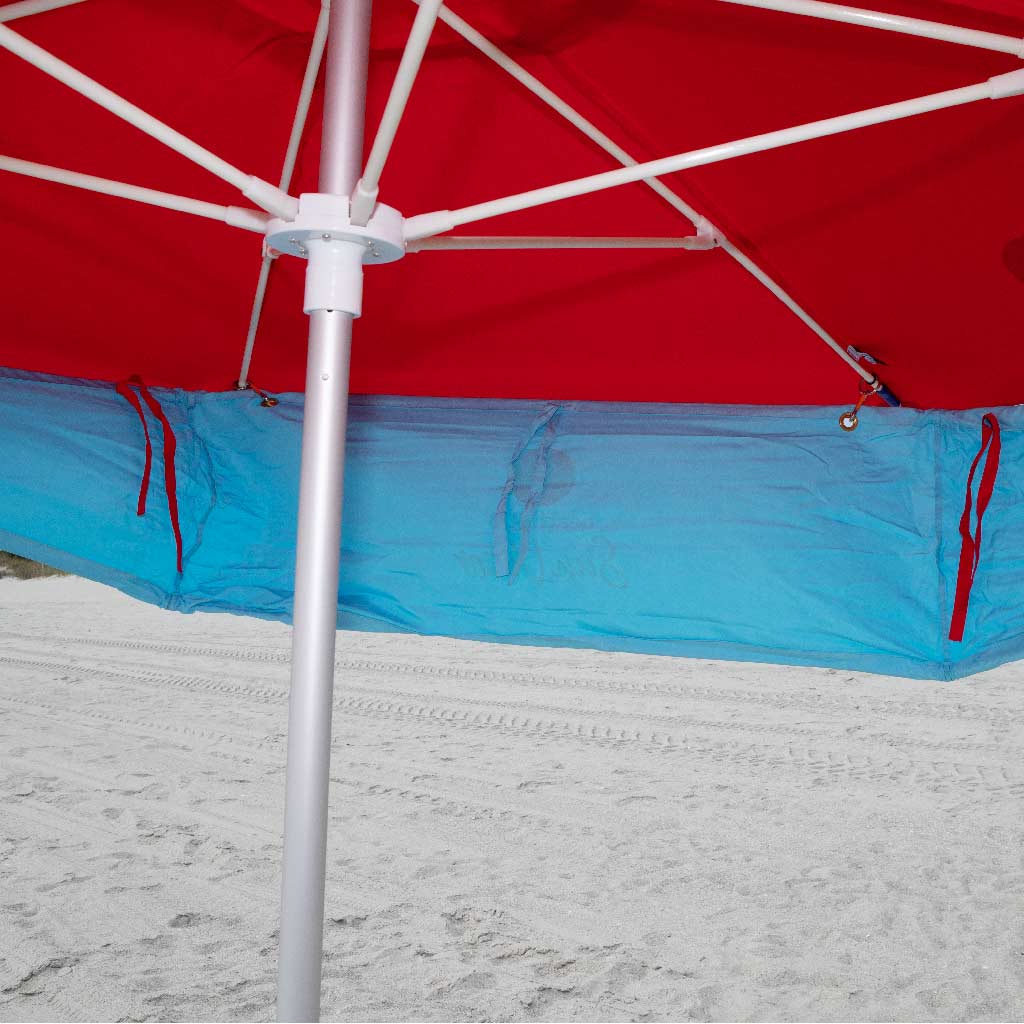 underneath red beach umbrella with addon sun shade